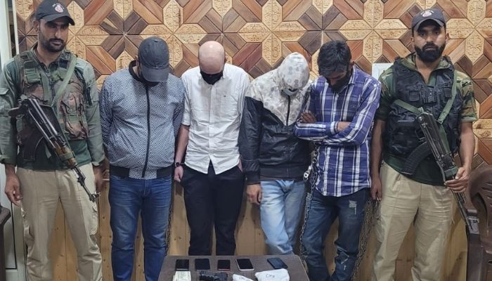 Srinagar Police apprehended Four drug peddlers along with 5 bottles of banned cough syrup and one Toy pistol